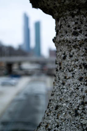 Distant city between stone columns.